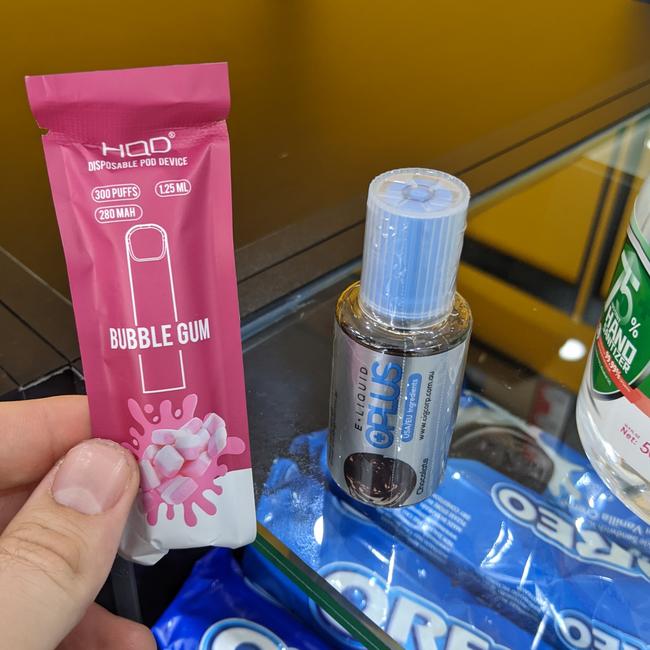 A vial of chocolate-flavoured E-Liquid Plus and bubblegum-flavoured HQD Disposable Pod Device, both of which contained nicotine, shown to our reporter at a Logan vape shop.