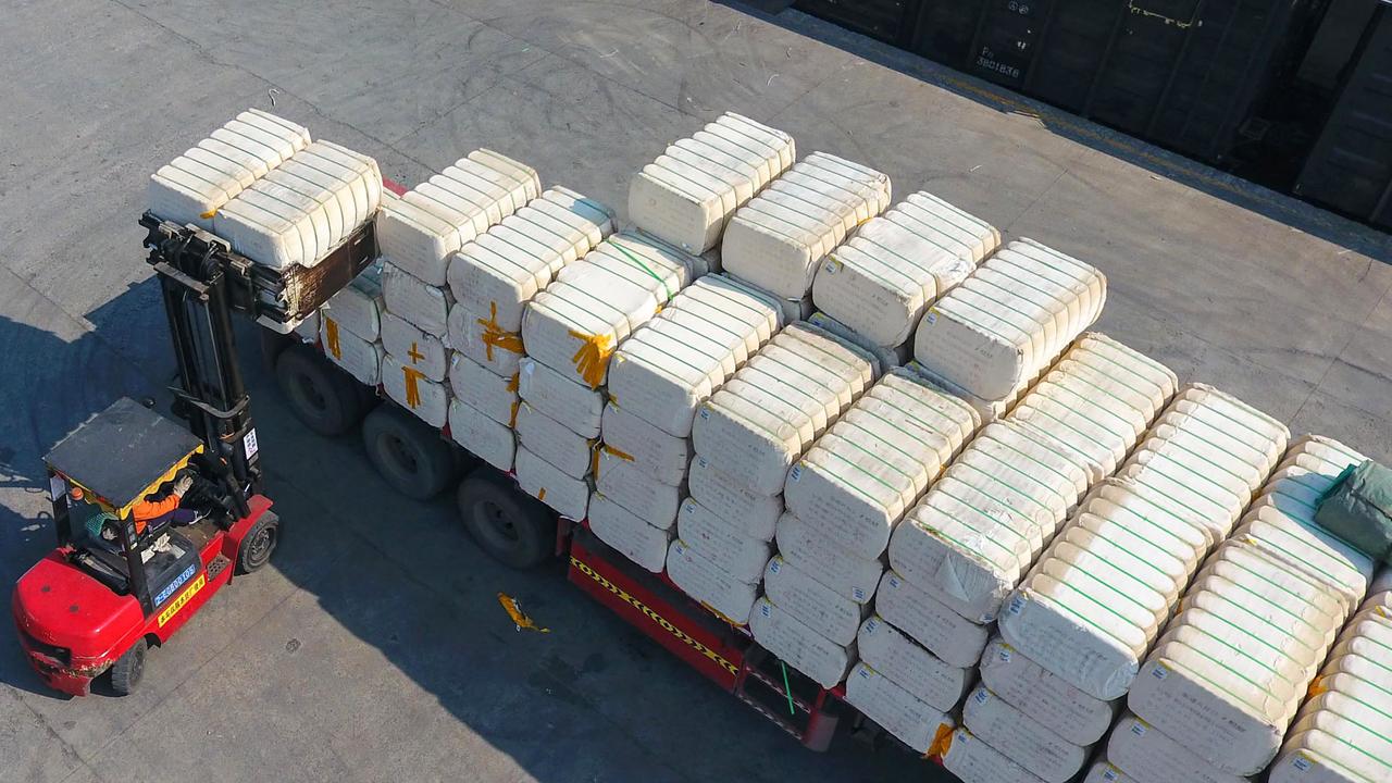 A worker unloading cotton picked from Xinjiang at a railway station in Jiujiang. Picture: AFP