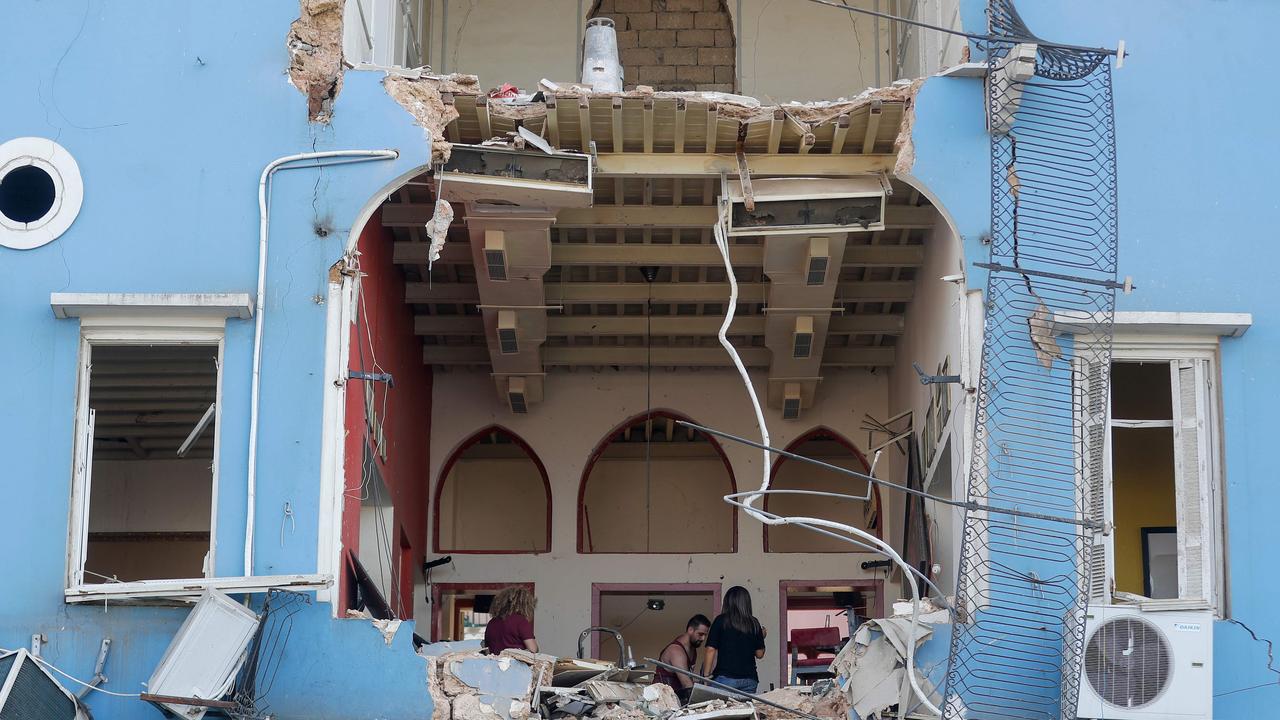 A Lebanese couple inspect the damage to their house. Picture: AFP