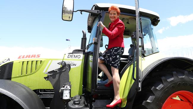 Pauline Hanson climbs down from the tractor she drove to the front door of Parliament House on Monday. Picture: Kym Smith