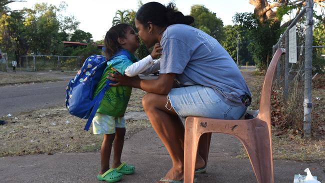 Ludmilla Primary School student Gordon May gives mum Shaqkayla Bading a goodbye kiss on his way to class with the help of the Bagot Community walking school bus. Picture: Sierra Haigh