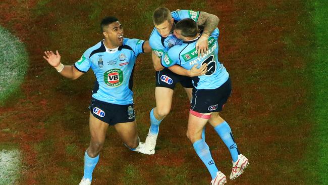 Trent Hodkinson celebrates his try with Blues teammates. Picture: Adam Taylor