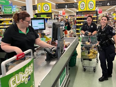 Police officers gather much-needed supplies at Woolworths Ingham. Picture: Cameron Bates.