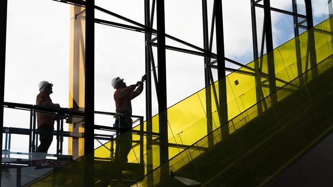 The glass panels are lifted into place at Kellyville train station.