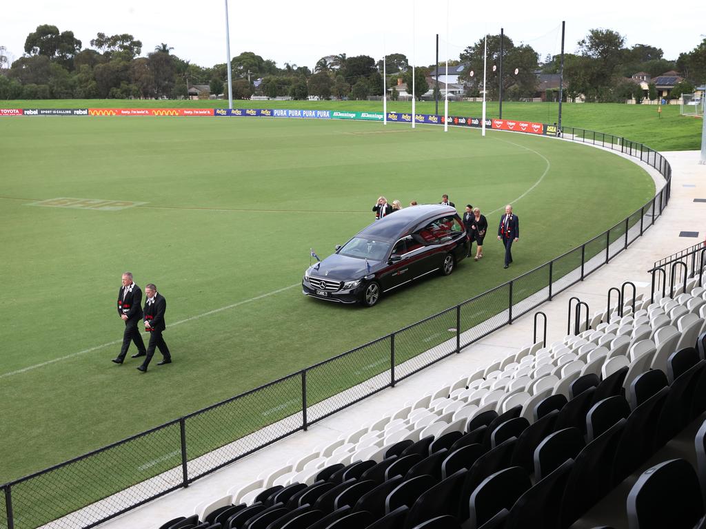 Family and friends follow the hearse carrying Shane Warne’s coffin for a lap of the ground. Picture: David Caird