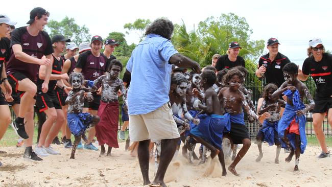 Essendon's first to fourth-year players dance with students at Maningrida. Picture: NATALIE MacGREGOR