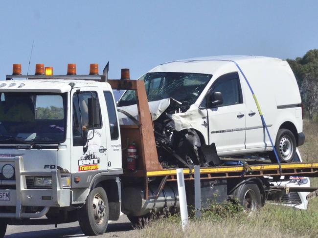 A tow truck moves a van from the scene of a fatal crash on the Bruce Highway near Bowen where a woman died.