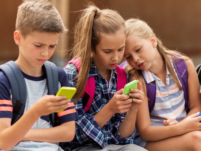 Children using smartphone devices at school. Picture: iStock.