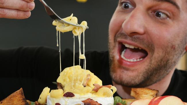 Alessandro Vicinanza samples the latest creation at Salt Meats Cheese. Picture: Glenn Hampson.