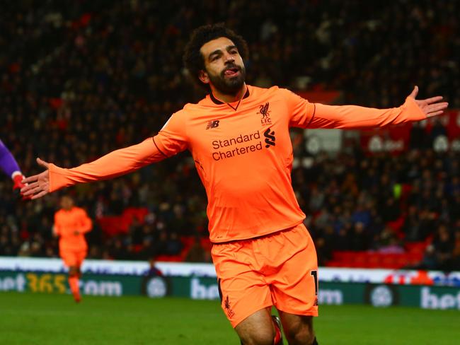 Liverpool's Egyptian midfielder Mohamed Salah celebrates scoring their third goal during the English Premier League football match between Stoke City and Liverpool at the Bet365 Stadium in Stoke-on-Trent, central England on November 29, 2017. / AFP PHOTO / Geoff CADDICK / RESTRICTED TO EDITORIAL USE. No use with unauthorized audio, video, data, fixture lists, club/league logos or 'live' services. Online in-match use limited to 75 images, no video emulation. No use in betting, games or single club/league/player publications.  /