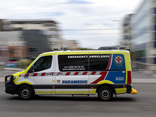 MELBOURNE, AUSTRALIA - NewsWire Photos FEBRUARY 13, 2022: An ambulance speeds away from the Royal Melbourne Hospital. Ambulance, Generic.Picture: NCA NewsWire / David Geraghty