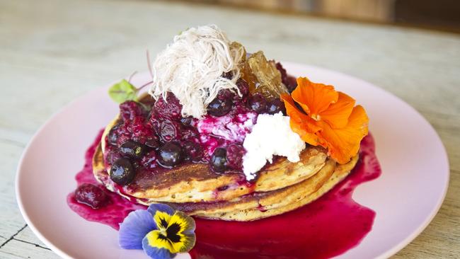 Double Barrel Kitchen's new menu item — protein pancakes topped with ricotta, mixed berry compote and fresh local honeycomb.