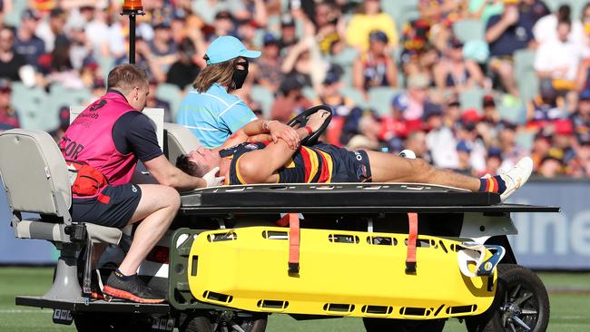 Kelly is taken from the ground after being knocked unconscious in a clash with Patrick Dangerfield. Picture: AFL Photos/Getty Images