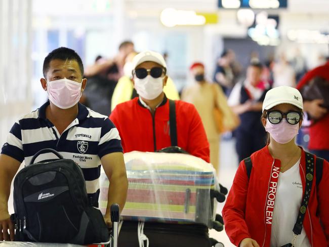 People wearing protective masks at Sydney airport.