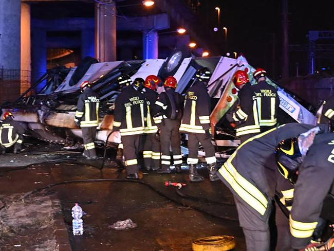 Firefighters work on the site of a bus accident on October 03, 2023 in Mestre, near Venice. At least 20 people were killed Tuesday when a bus plunged off a bridge in the northern Italian city of Venice, a city hall spokesman told AFP. The crash caused 