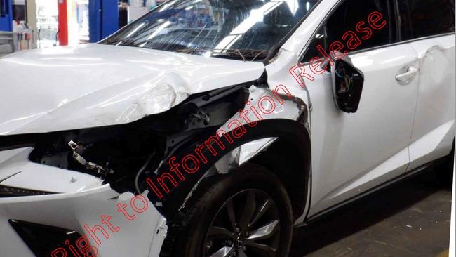 The crashed passenger side of the car with a blown tyre and a cracked side mirror.