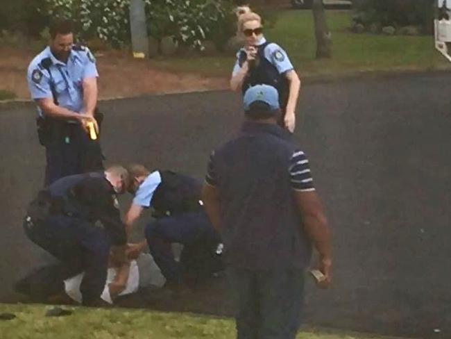 NSW Police officers restrain Ihsas Khan after Khan allegedly set upon Minto resident Wayne Greenhalgh with a large hunting knife. Picture supplied