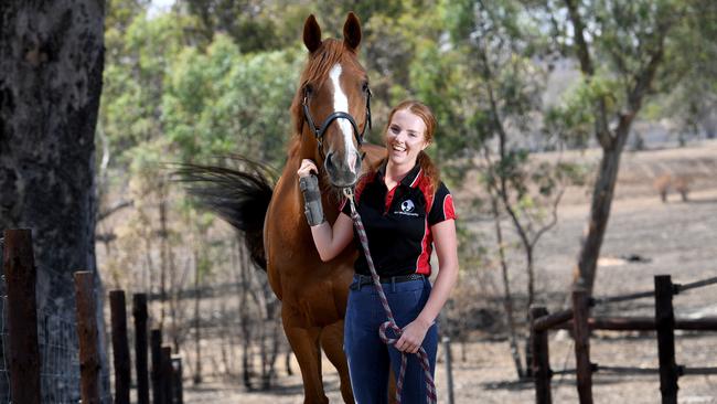 Jessie Smith with her horse Fire Storm who survived the bushfire. Picture: Tricia Watkinson