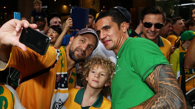 Tim Cahill poses for selfies with Socceroos fans. Picture: Brett Costello