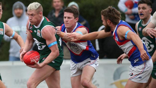 Josh Caddy breaks away from Billy Hogan and Jesse Tardio. Picture: Hamish Blair