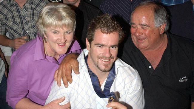 Footballer Mark Ricciuto wearing the Brownlow Medal with his parents Carolyn and Murray at the Alma Tavern in Norwood in 2003.