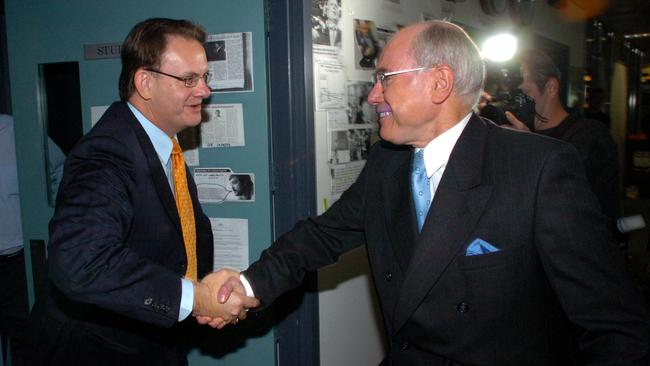 Opposition Leader Mark Latham (left) and Prime Minister John Howard cross paths in the ABC radio studios in Sydney during the campaign for a Federal election. Picture: John Feder