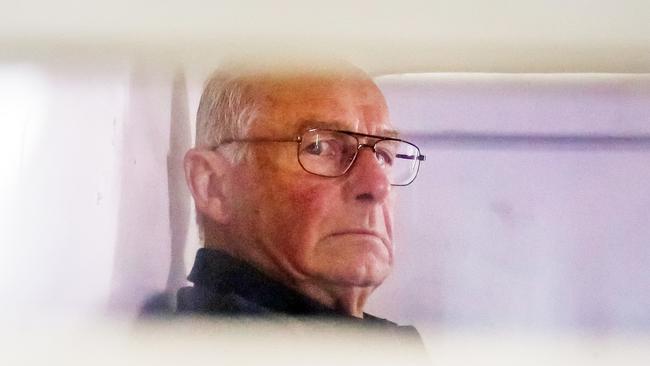 Roger Rogerson inside a police truck being taken into Bankstown Court to face charges relating to the murder of Jamie Gao. Picture: Craig Greenhill