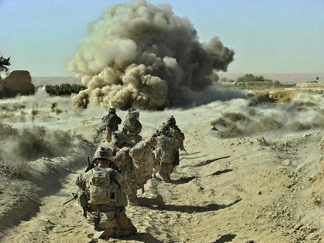 (FILES) In this file photo dust kicks off the ground during an operation by US Army soldiers attached to the 2nd platoon, C-Coy. 1-23 Infantry based at Zangabad foward operating base in Panjwai ditrict after Anti Personnel Obstacle Breaching System -- abbreviated as A-POBS (charges fired by rocket and trigger safe detonation of IED's used to make roadside bombs) -- detonate on a nearby road during a dawn operation at Naja-bien village on September 23, 2012. - US President Joe Biden will formally announce on April 14, 2021 the withdrawal of all US troops from Afghanistan before this year's 20th anniversary of the September 11 attacks, finally ending America's longest war despite mounting fears of a Taliban victory, officials said. The drawdown delays only by around five months an agreement with the Taliban by former president Donald Trump to pull troops, amid a growing consensus in Washington that little more can be achieved. (Photo by Tony KARUMBA / AFP)