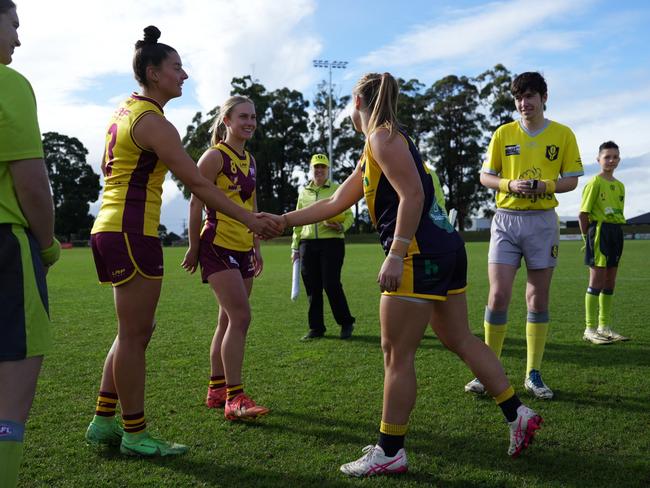 NWFL captains Libby Haines and Olivia Smith shake hands with SFL captain Brieanna Barwick ahead of the 2025 Tasmanian Representative Series match at Dial Park. Picture: Joeb Dedman.