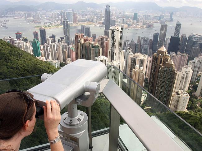 A woman looking at the view from the Peak Tower prior to its opening after extensive renovation in Hong Kong, 29 Aug 2006 : AFP PicMike/Clarke - aerials telescope travel tourism China skyline