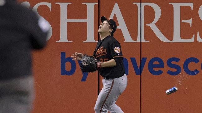 Baltimore Orioles' Hyun Soo Kim gets under a fly ball as a can falls past him.