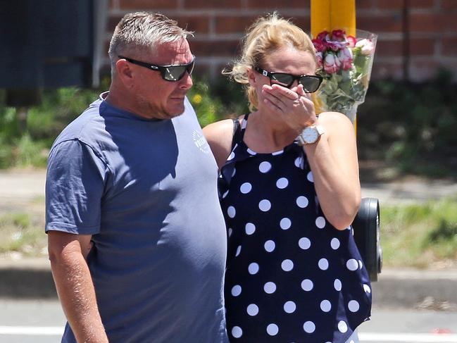 DAILY TELEGRAPH - Pictured at the scene where a 9 year old girl was killed after being hit by a truck just after 4pm on Monday at Boomerang Place, Cambridge Gardens, is the girls Uncle and his partner leaving flowers. Picture: Tim Hunter.