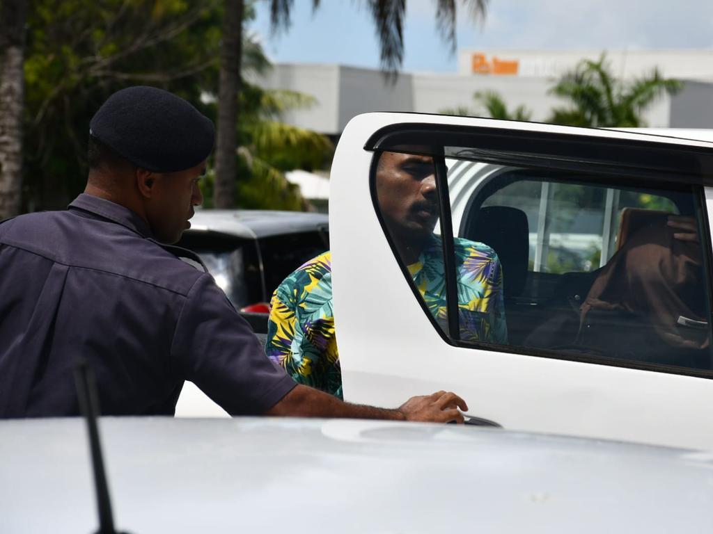 Ilaisa Tanoa Degei, 24, is escorted from a police vehicle to a holding cell at Nadi Magistrate’s Court on Monday.