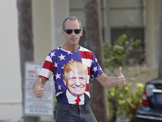 A supporter give a thumbs up before the motorcade carrying President Donald Trump passes by on Sunday, March 24, 2019, in West Palm Beach, Fla. (AP Photo/Terry Renna)