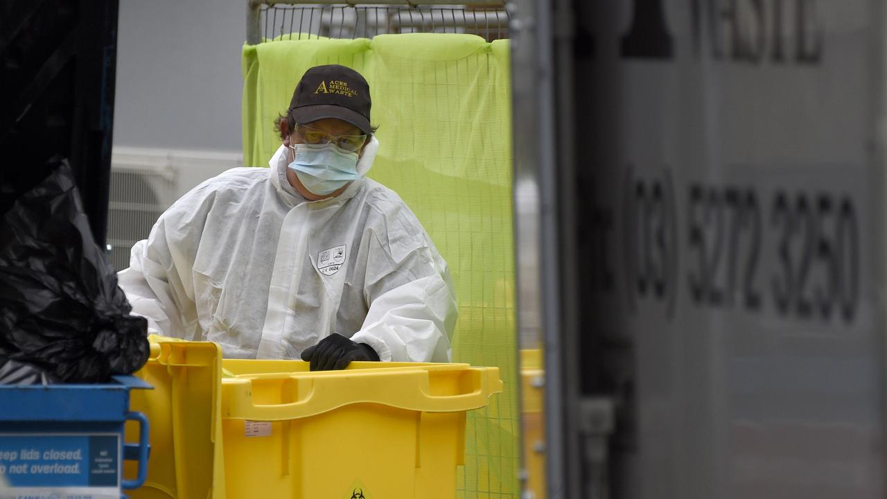 A worker wearing full PPE removes bags of clinical waste from Arcare Maidstone Aged Care in Melbourne's west after the facility went into lockdown on May 31. Picture: NCA NewsWire/Andrew Henshaw