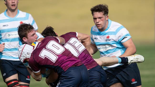 NSW player Connor Wilkin tackled by Nico Buckley and Sean Weir at the tournament. Picture: Julian Andrews