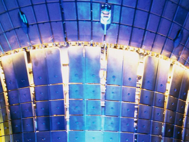 Original caption: The interior chamber of the ASDEX Upgrade Fusion Reactor (Axially Symmetric Divertor Experiment), where the plasma used in fusion reactions is created. It began operation in 1990 and is currently the largest fusion device in Germany. Technicians are preparing the machine for the next set of tests. Max Planck Institut For Plasma Physics, Munich, Germany. --- Image by © Peter Ginter/Science Faction/Corbis