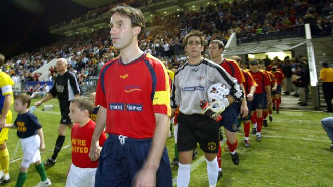 Aurelio Vidmar leads Adelaide United out at Hindmarsh Stadium for its first game in the former National Soccer League in 2003.