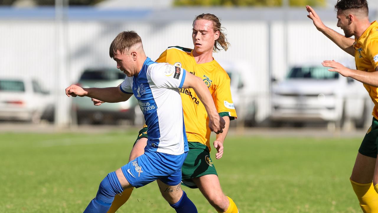 Cumberland United's Karl Phelps battles with Adelaide Olympic'sZak Waters in theri FFSA Cup clash on May 5, 2018.Credit: Adam Butler.