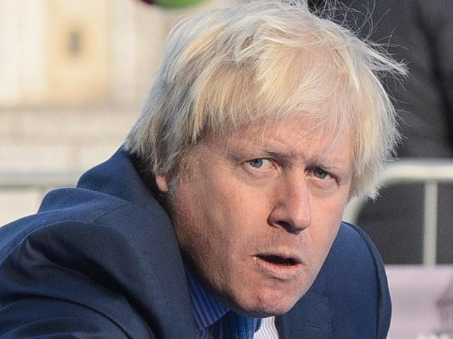 London Mayor Boris Johnson takes part in a photocall near Tower Bridge in central London, on November 24, 2014, to promote the forthcoming NEC Wheelchair Tennis Masters event. AFP PHOTO / LEON NEAL
