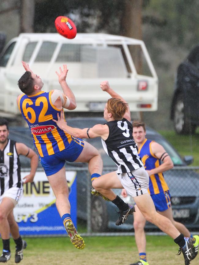 Crib Point's Nick Rutherford (No 9) tries to spoil Somerville’s Ben Crowe. Picture: David Trend