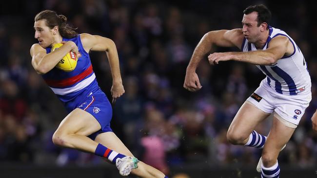 Marcus Bontempelli pushes of North Melbourne’s Todd Goldstein. Picture: Michael Klein