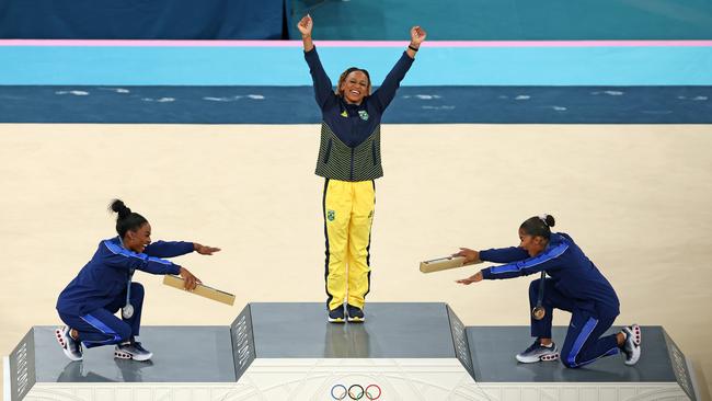 Gold medallist Rebeca Andrade (C) of Team Brazil, silver medallist Simone Biles (L) of Team United States and bronze medallist Jordan Chiles (R) of Team United States celebrate on the podium. Picture: Getty