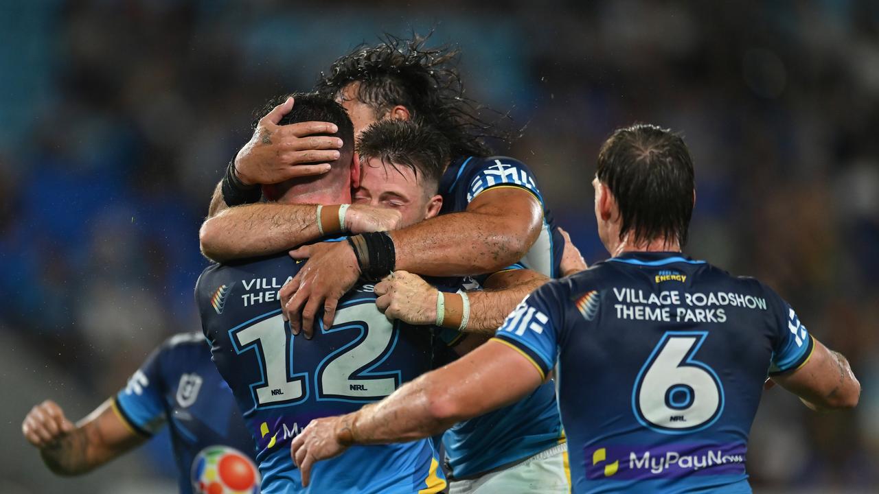 Titans player Beau Fermor celebrates with teammates after scoring a try against Newcastle Knights. Picture: Getty Images