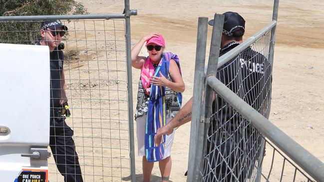 Black Swan Lake protest at Bundall goes to another level, with protesters chaining themselves to the fence and then getting themselves arrested after running onto the worksite and stopping the trucks. Protester Lindy Donato stopped the trucks after wandering onto the worksite, before being escorted to the Paddy wagon. Picture Glenn Hampson