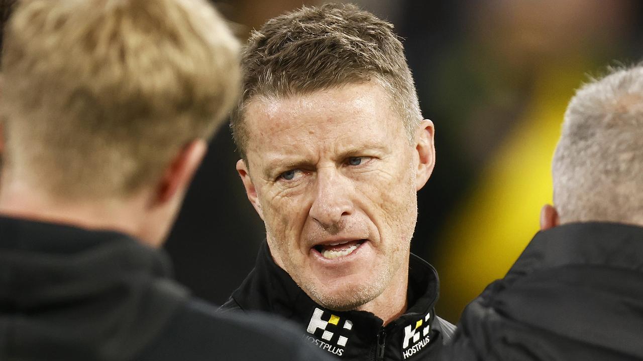 MELBOURNE, AUSTRALIA - JULY 11: Tigers head coach Damien Hardwick speaks to his coaches during the round 17 AFL match between Richmond Tigers and Collingwood Magpies at Melbourne Cricket Ground on July 11, 2021 in Melbourne, Australia. (Photo by Daniel Pockett/AFL Photos/via Getty Images)