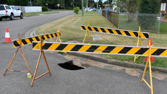 Several sink holes developed in several streets in Aitkenvale. This sink hole is deep and a black and blue pipe can be seen at the bottom. Picture: Evan Morgan
