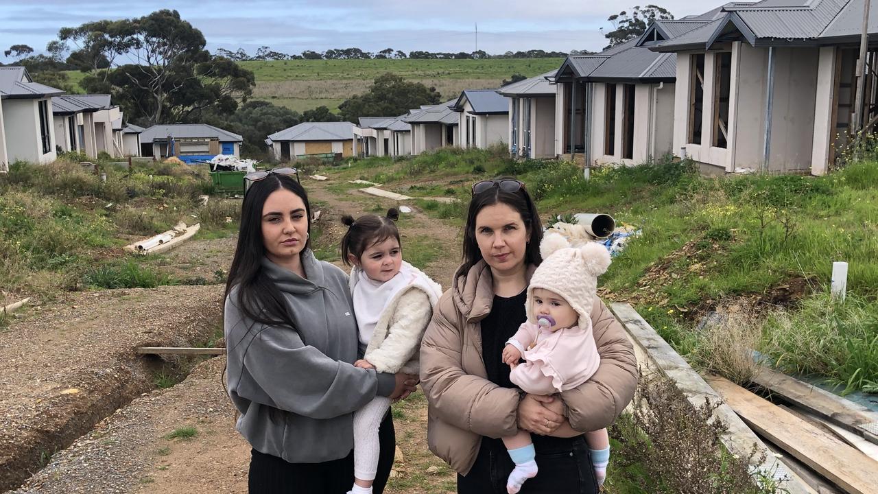 First-time homeowners Devon Craig with her daughter Willow, 2, and Zoe Grzeczkowski, with her nine-month-old daughter Elena, are among Felmeri customers left with unfinished homes at O’Halloran Hill. Picture: Shashi Baltutis