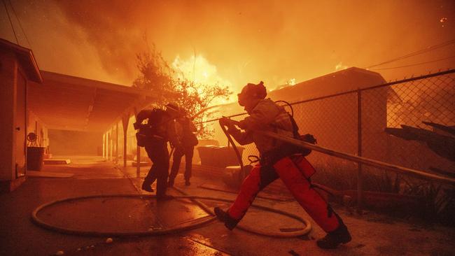 Firefighters protect a structure as the Eaton Fire advances. Picture: AP