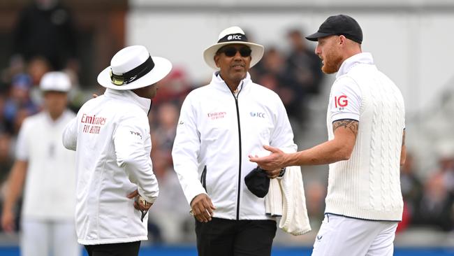 Umpires Nitin Menon (l) and Joel Wilson talk to England captain Ben Stokes after they deem the light not good enough to continue with fast bowlers during day four. (Photo by Stu Forster/Getty Images)